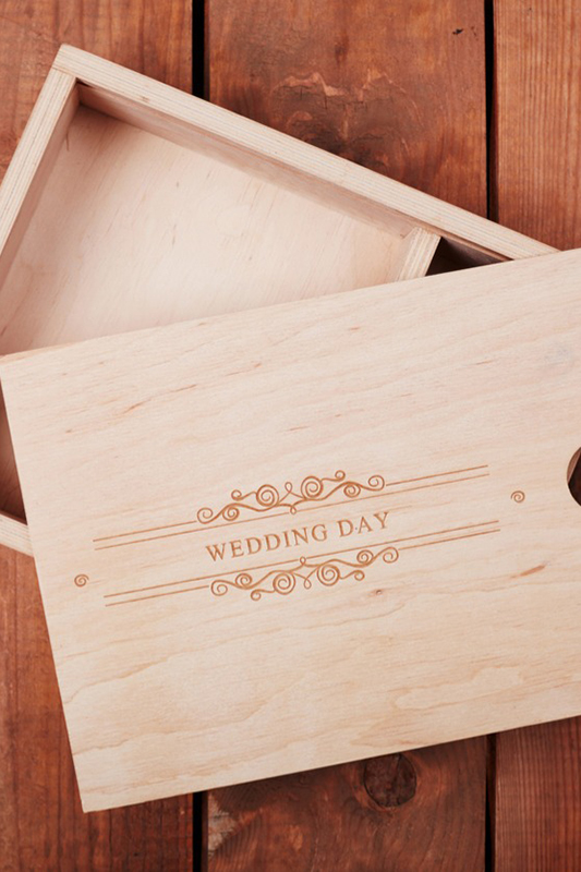 wooden box with engraved text saying wedding day